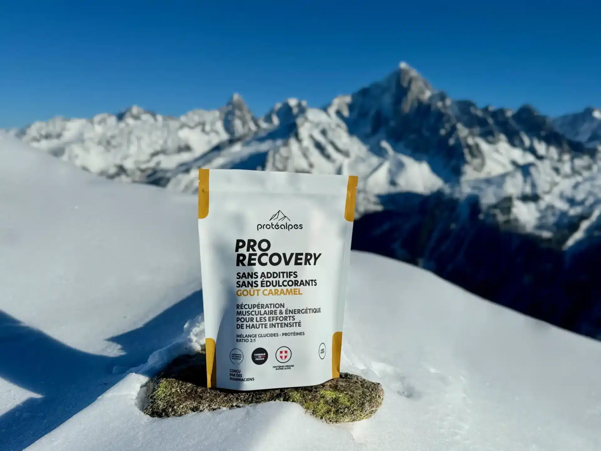 Produit Protéalpes Pro Recovery, sans additifs, posé sur la neige alpine; nutrition sportive naturelle et haut de gamme.